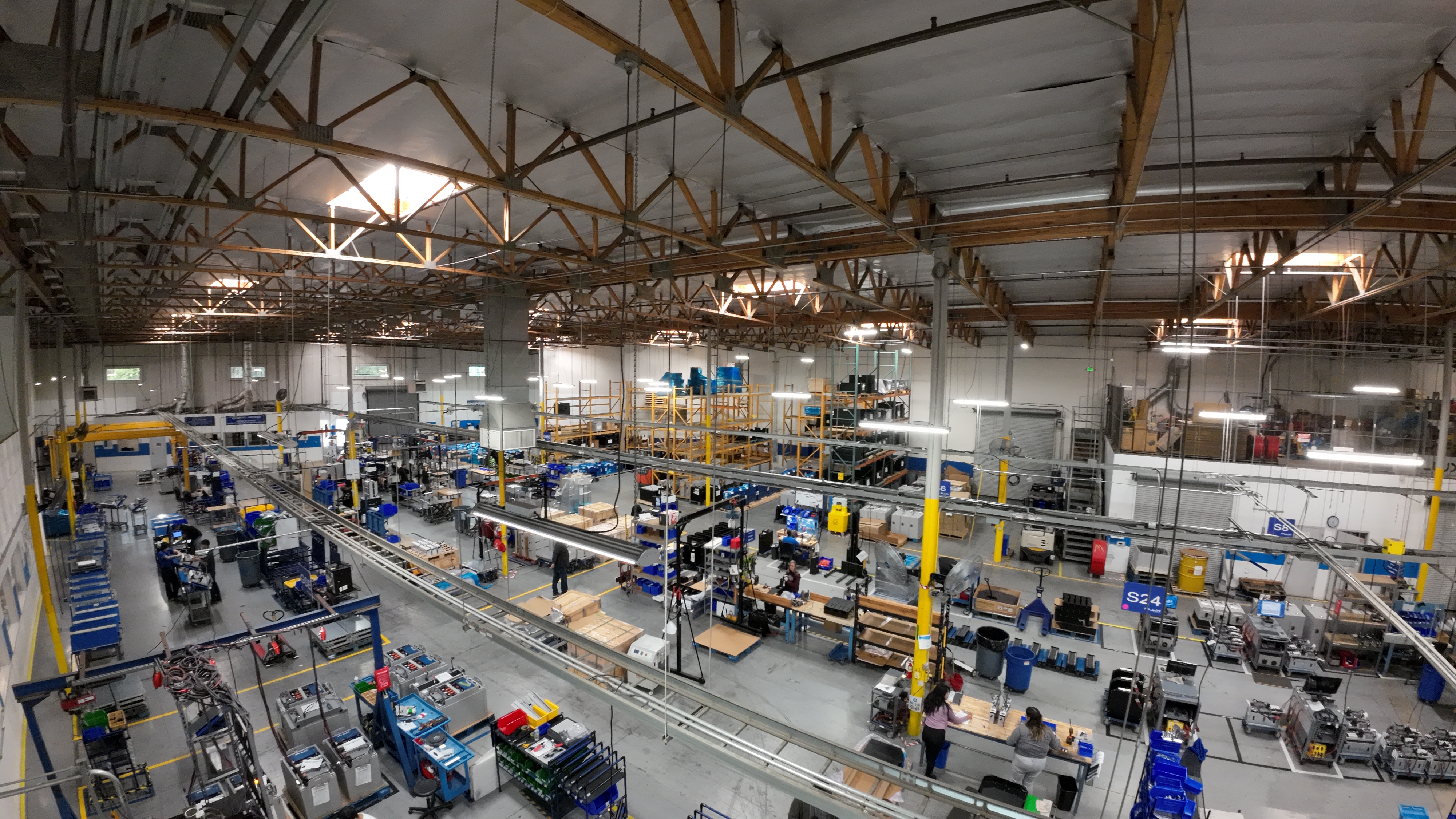 Workers working inside a large warehouse