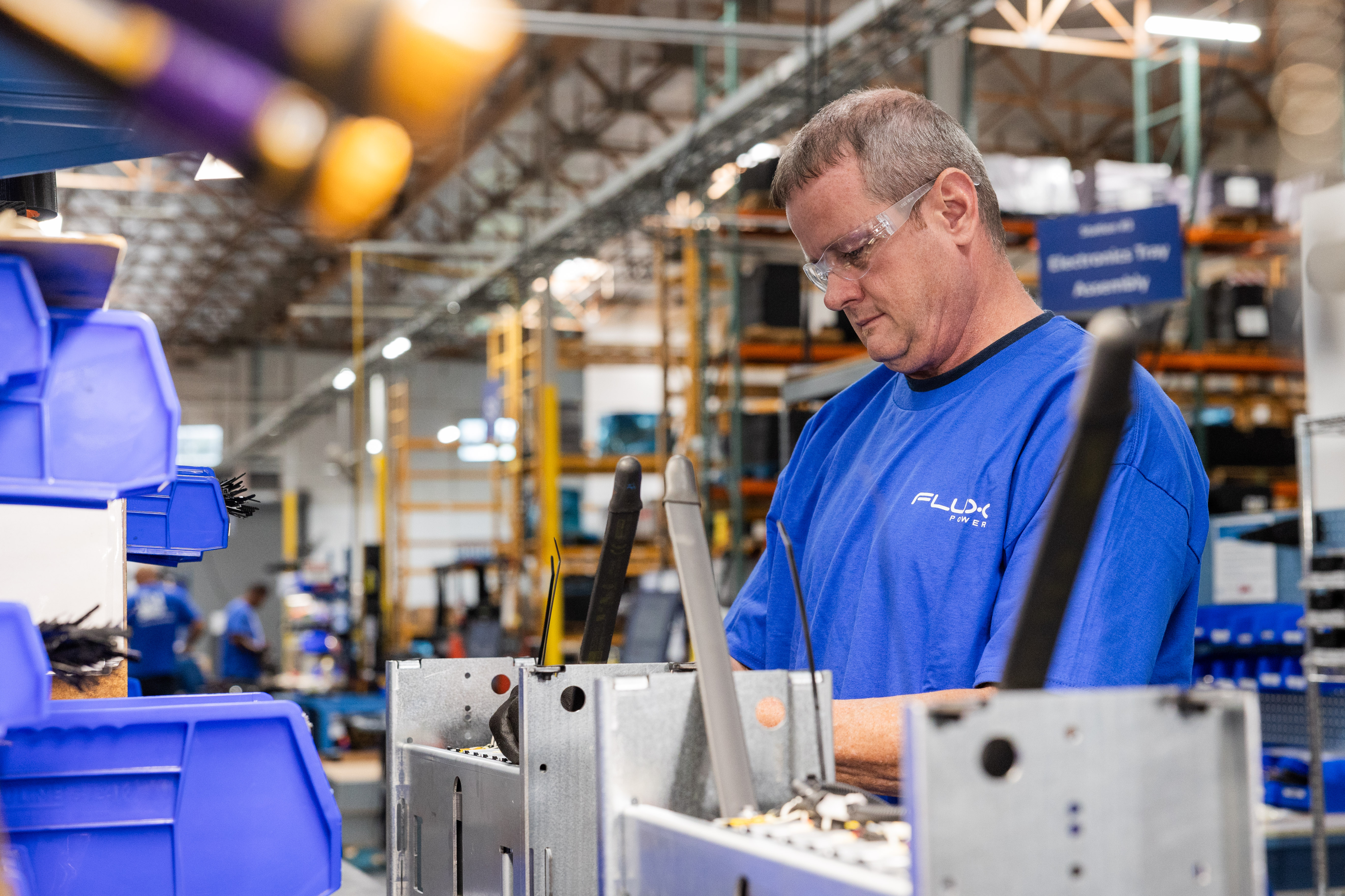 Worker in warehouse charging lithium-ion battery