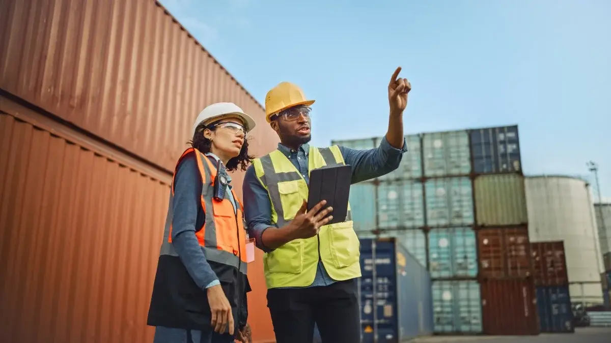 Lithium ion powered forklift loading freight at a port logistics dock